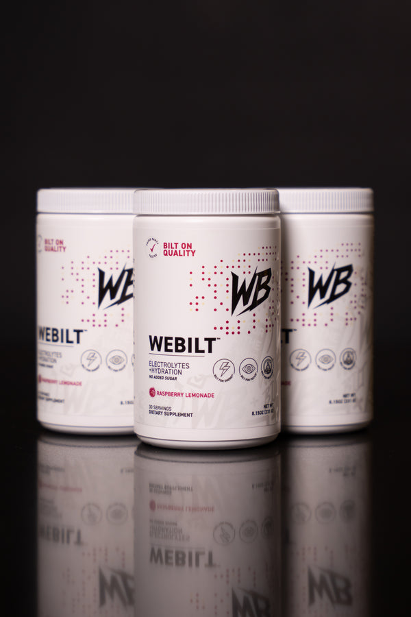 Three containers of WeBilt electrolyte powder on a reflective surface with a black background